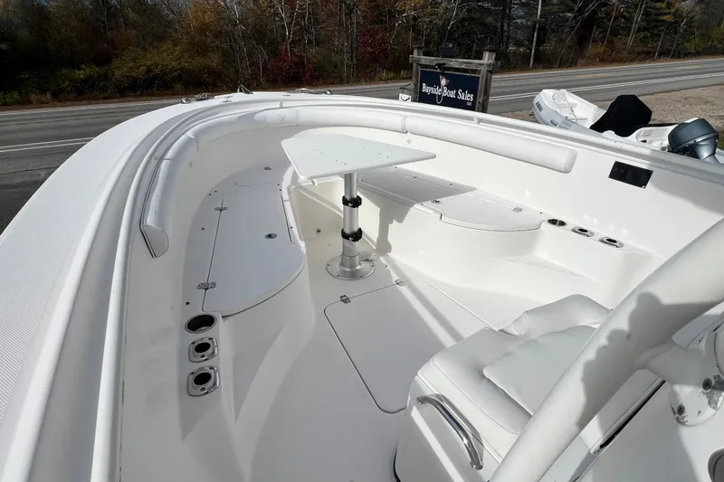 Slide: The Image of 2008 Edgewater 318CC boat interior with seating and table, displayed at Bayside Boat Sales. - 11