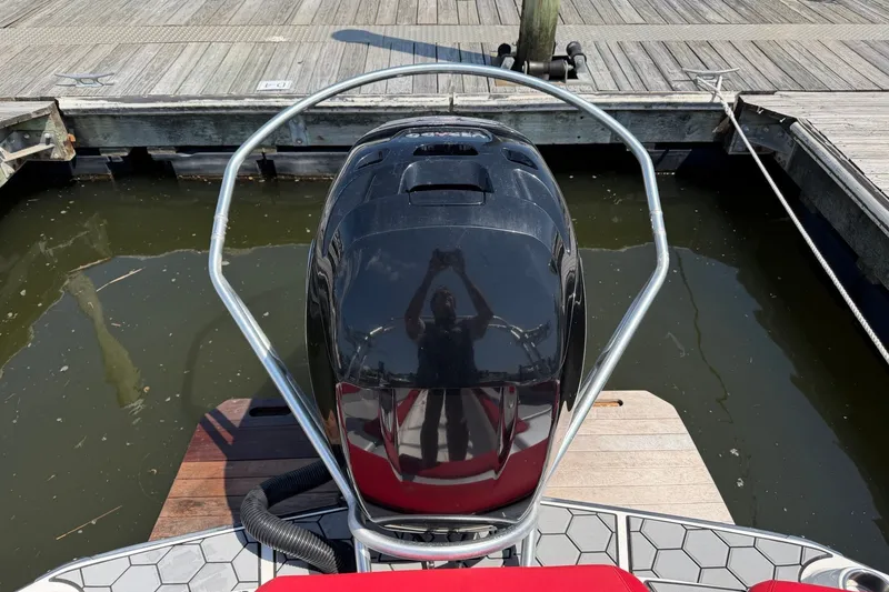 Slide: The Image of 2017 MasterCraft NXT20 Global Edition boat engine at dock, reflecting surroundings. - 2