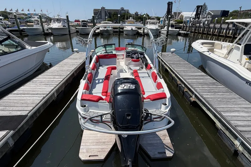 Slide: The Image of 2017 MasterCraft NXT20 Global Edition boat docked at marina with red seating. - 1