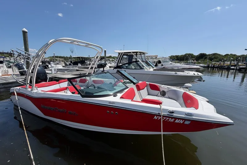 Slide: The Image of 2017 MasterCraft NXT20 Global Edition boat docked, featuring red and white design. - 14