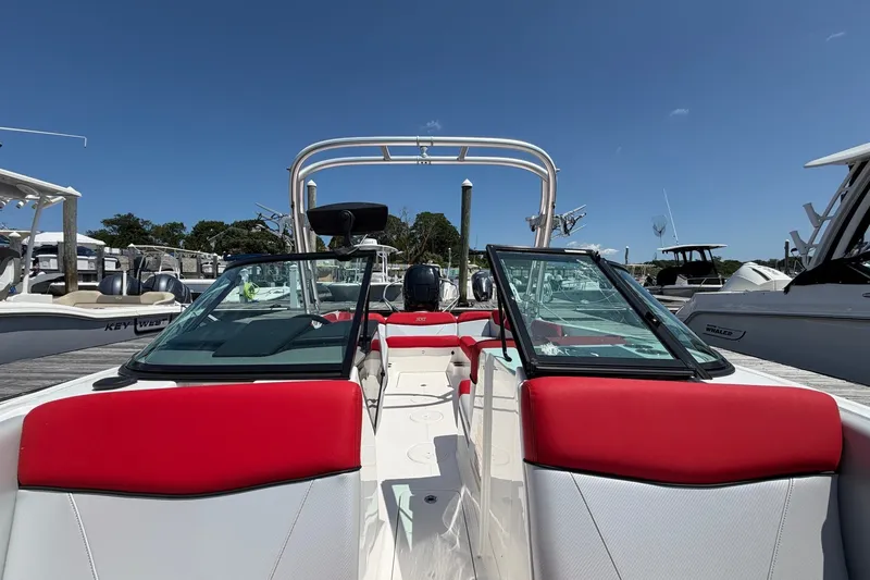Slide: The Image of 2017 MasterCraft NXT20 Global Edition boat with red and white interior at a marina. - 12