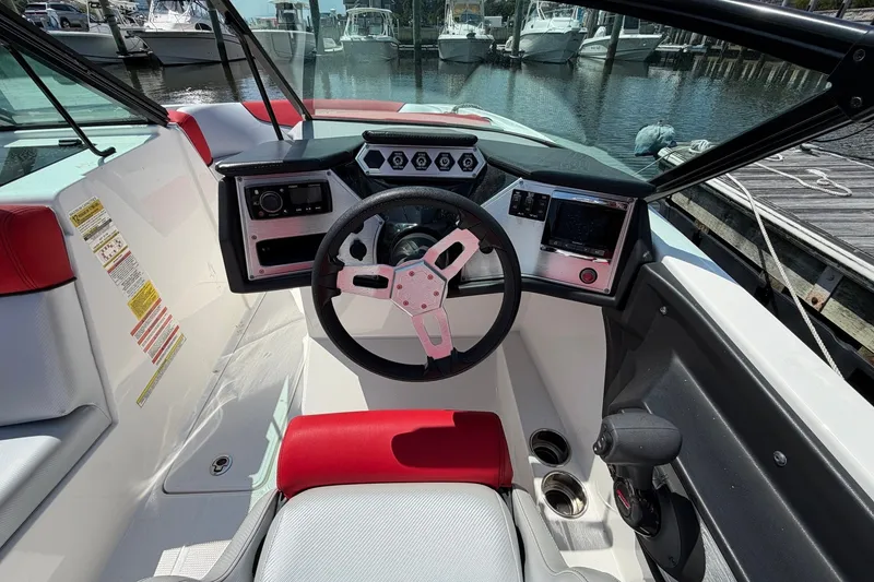 Slide: The Image of 2017 MasterCraft NXT20 Global Edition boat cockpit with steering wheel and control panel. - 11