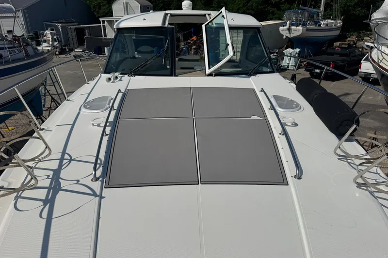 Slide: The Image of 2009 Cruisers Yachts 390 Sports Coupe on display at a marina, showcasing sleek design. - 8