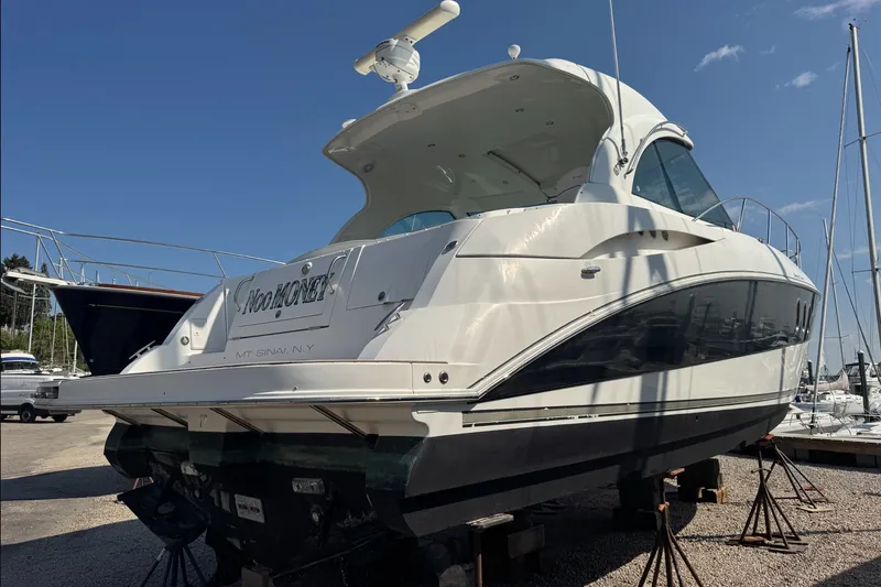 Slide: The Image of 2009 Cruisers Yachts 390 Sports Coupe on dry dock under clear blue sky. - 2