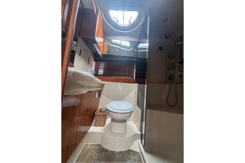 Slide: The Image of Luxurious bathroom in 2009 Cruisers Yachts 390 Sports Coupe with modern fixtures and porthole window. - 21