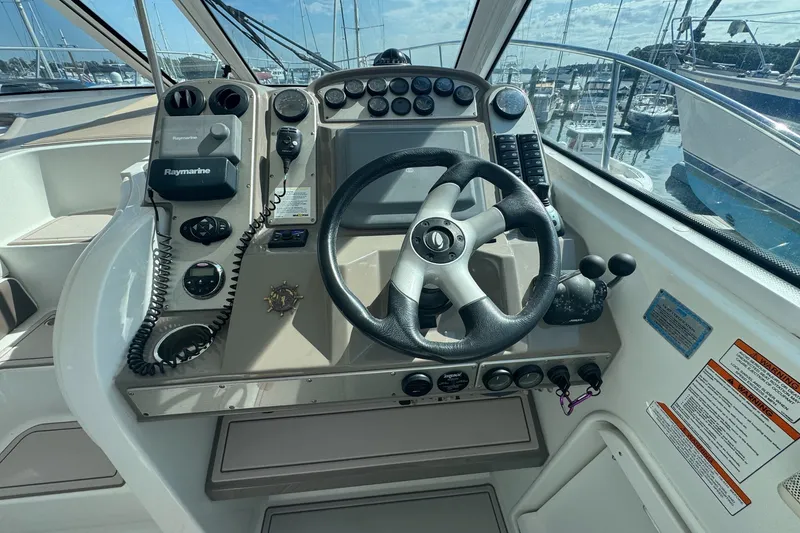 Slide: The Image of Cockpit of 2009 Cruisers Yachts 390 Sports Coupe with steering wheel and navigation controls. - 9