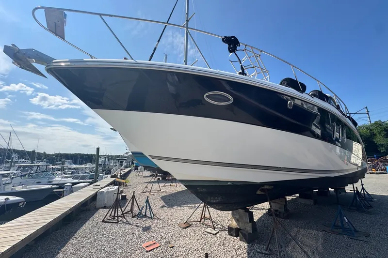 Slide: The Image of 2009 Cruisers Yachts 390 Sports Coupe on dry dock under clear blue sky. - 4