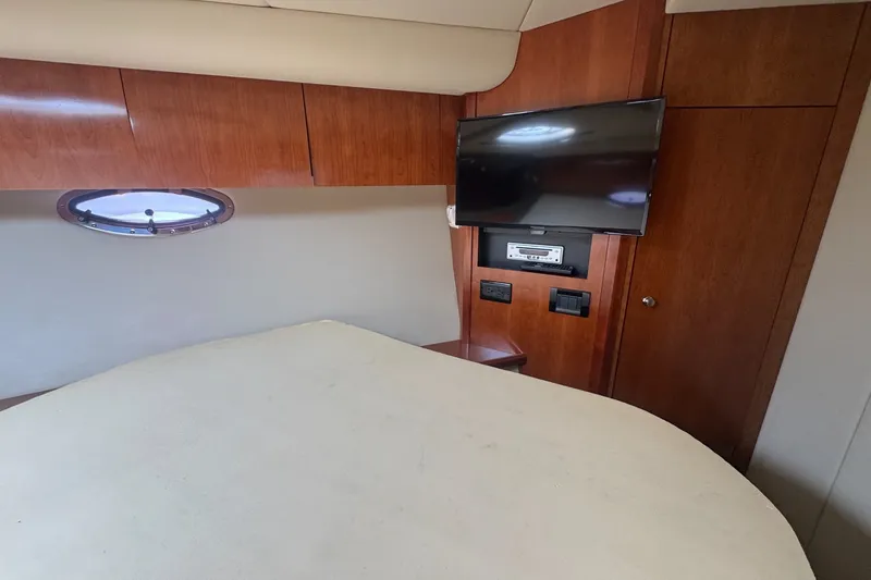 Slide: The Image of Interior of 2009 Cruisers Yachts 390 Sports Coupe with TV and wood paneling. - 24