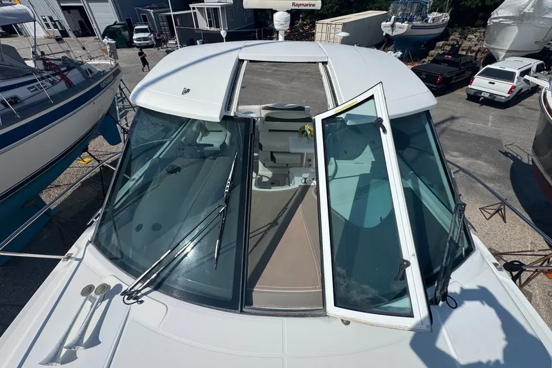 Slide: The Image of 2009 Cruisers Yachts 390 Sports Coupe with open sunroof and windshield, docked at marina. - 7