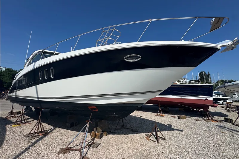 Slide: The Image of 2009 Cruisers Yachts 390 Sports Coupe on stands, displayed outdoors. - 3