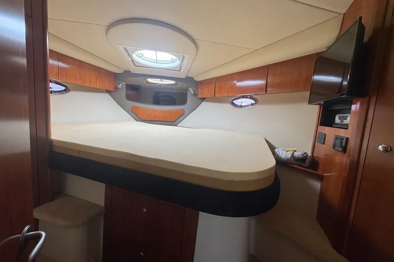 Slide: The Image of Luxurious cabin interior of 2009 Cruisers Yachts 390 Sports Coupe with wood accents and skylight. - 23