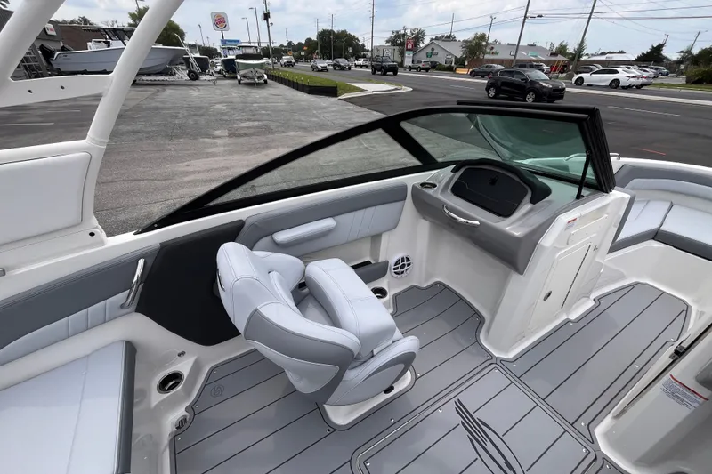 Slide: The Image of Interior view of 2027 Chaparral 21 SSi OB boat, featuring sleek seating and modern dashboard. - 14
