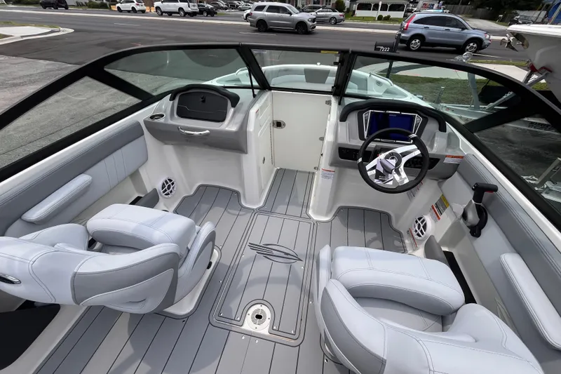 Slide: The Image of Interior of 2027 Chaparral 21 SSi OB boat, featuring modern seating and steering wheel. - 10