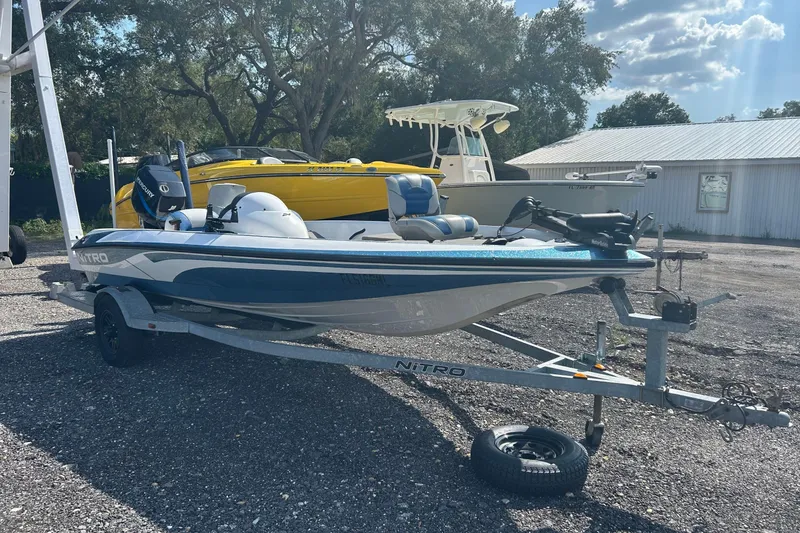 Slide: The Image of 2004 Nitro 700 LX SC boat on trailer, parked outdoors under sunny skies. - 2