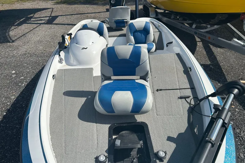 Slide: The Image of 2004 Nitro 700 LX SC boat with blue and gray seating, parked on a trailer. - 3