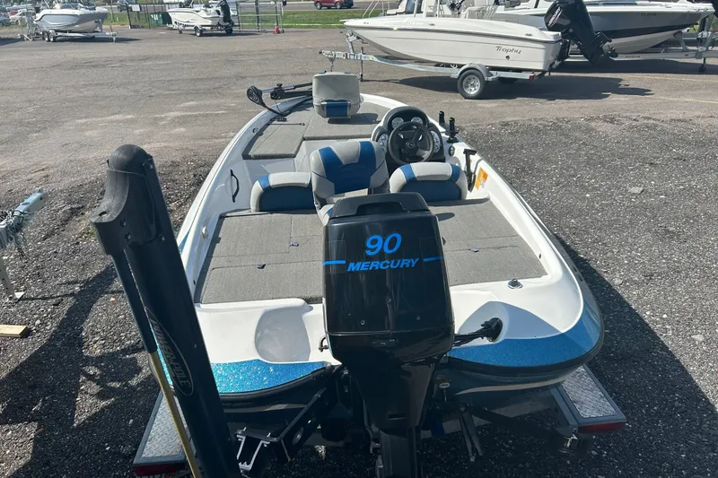Slide: The Image of 2004 Nitro 700 LX SC boat with Mercury 90 engine in a parking lot. - 4