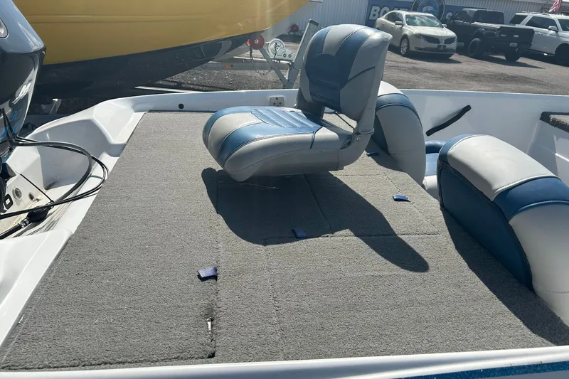 Slide: The Image of 2004 Nitro 700 LX SC boat interior with blue and gray seating on a carpeted deck. - 8