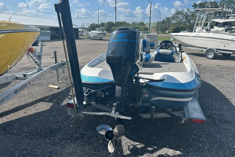 Slide: The Image of 2004 Nitro 700 LX SC boat with Mercury 90 engine on trailer in sunny lot. - 5