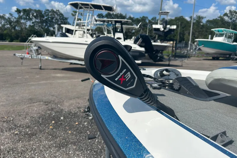 Slide: The Image of Trolling motor on 2004 Nitro 700 LX SC boat, with other boats in the background. - 12