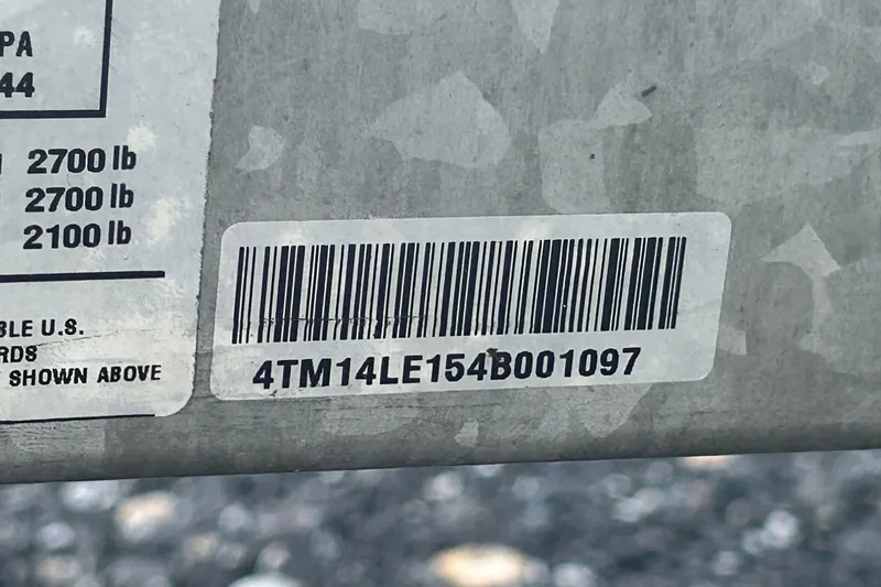 Slide: The Image of Barcode and label on a 2004 Nitro 700 LX SC, showing weight specifications. - 18