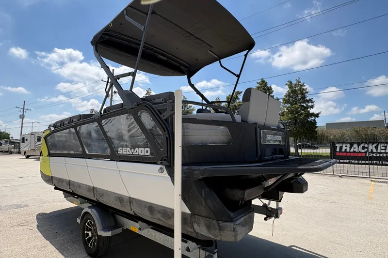 Slide: The Image of 2023 Seadoo Switch 21 boat on trailer under sunny sky. - 6