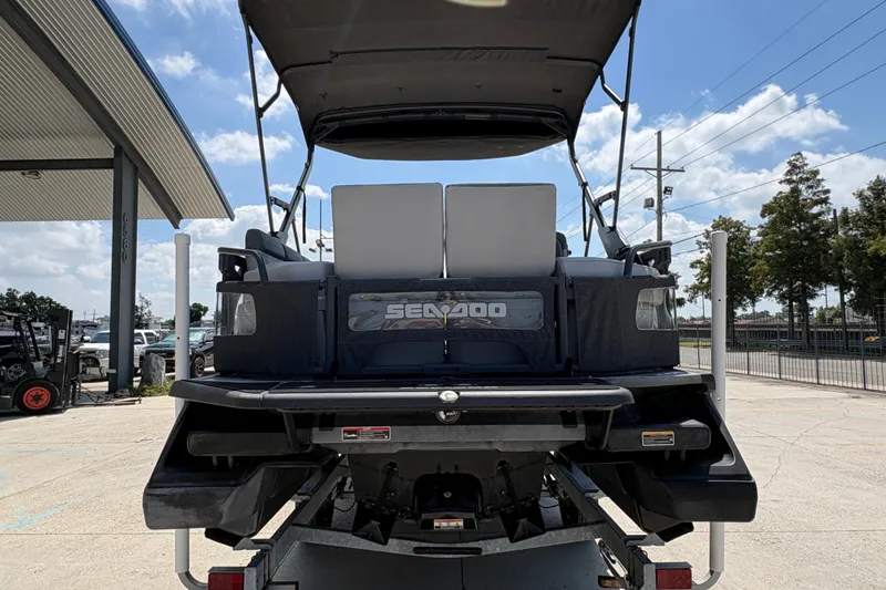 Slide: The Image of 2023 Seadoo Switch 21 pontoon boat rear view at a dealership. - 5