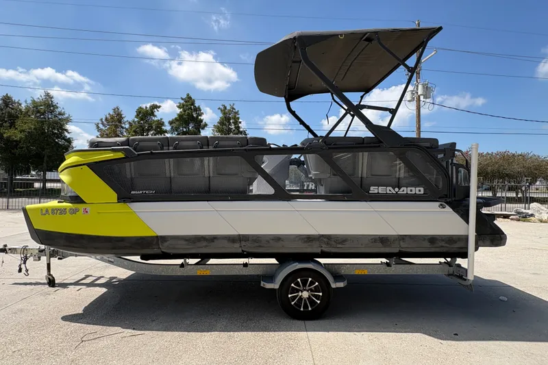 Slide: The Image of 2023 Seadoo Switch 21 boat on trailer, featuring a sleek design and vibrant yellow accents. - 7
