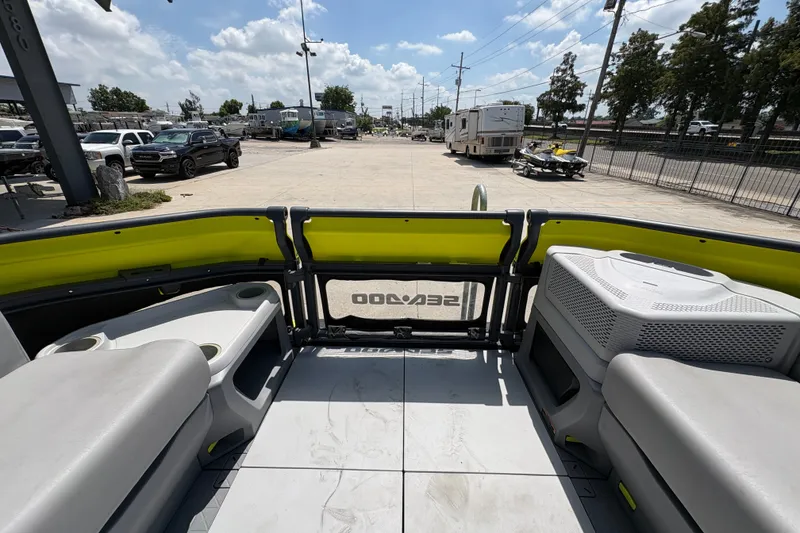 Slide: The Image of 2023 Seadoo Switch 21 interior view with seating and storage, parked outdoors. - 12