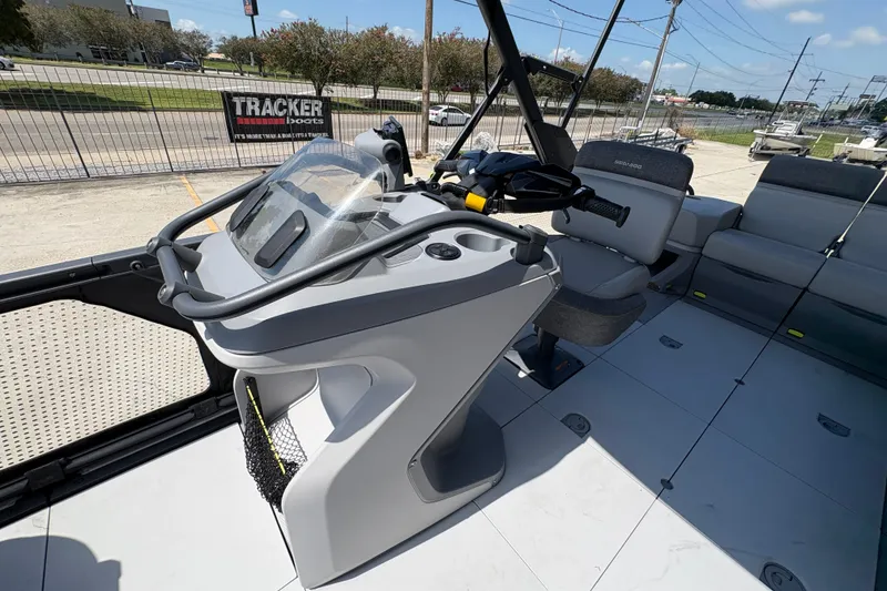 Slide: The Image of 2023 Seadoo Switch 21 boat interior with steering console and seating area. - 15