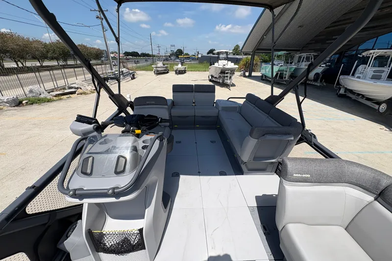 Slide: The Image of 2023 Seadoo Switch 21 boat interior with spacious seating and modern helm controls. - 14