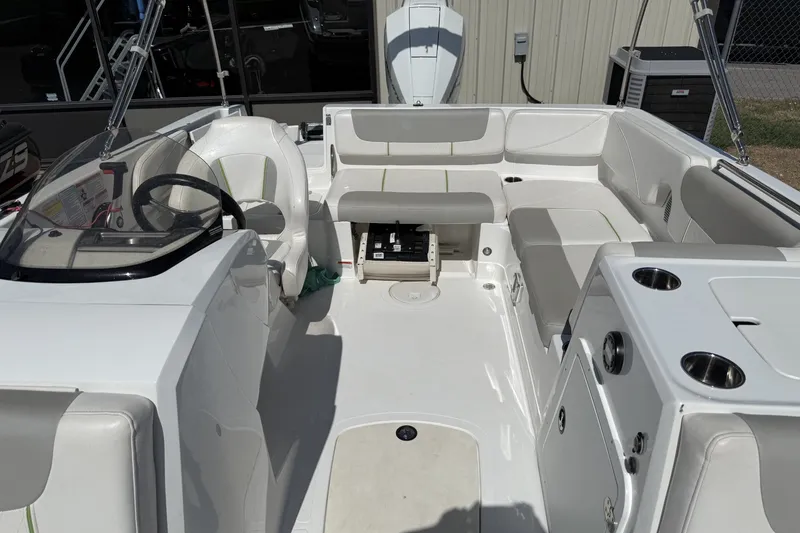 Slide: The Image of 2021 Tahoe 2150 boat interior with seating, steering wheel, and cup holders. - 8