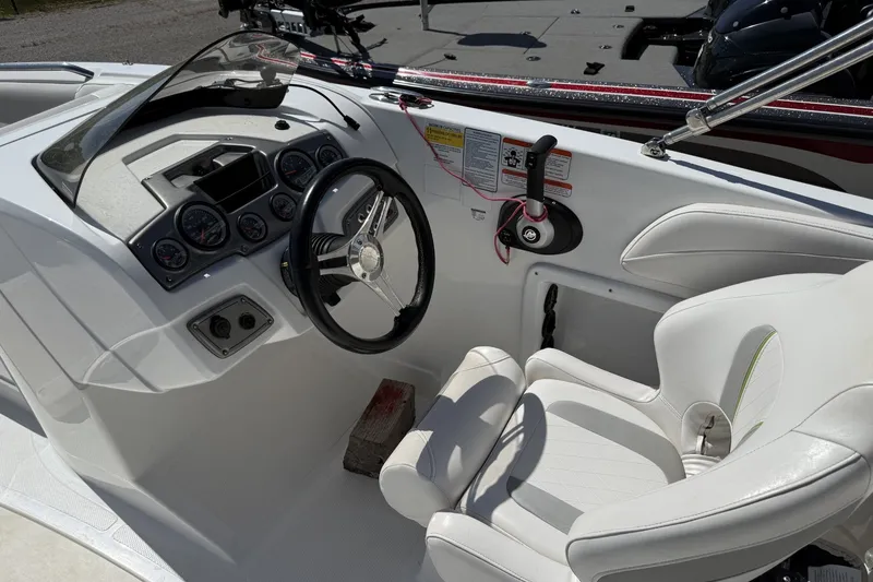 Slide: The Image of Interior of a 2021 Tahoe 2150 boat featuring steering wheel and dashboard controls. - 5