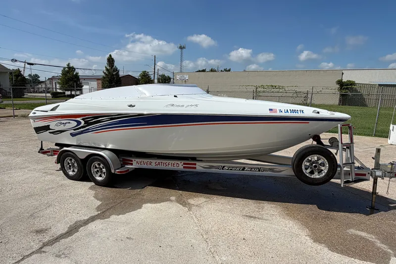 The Image of 2004 Baja 245 Performance boat on trailer, featuring sleek design and vibrant graphics. - 1