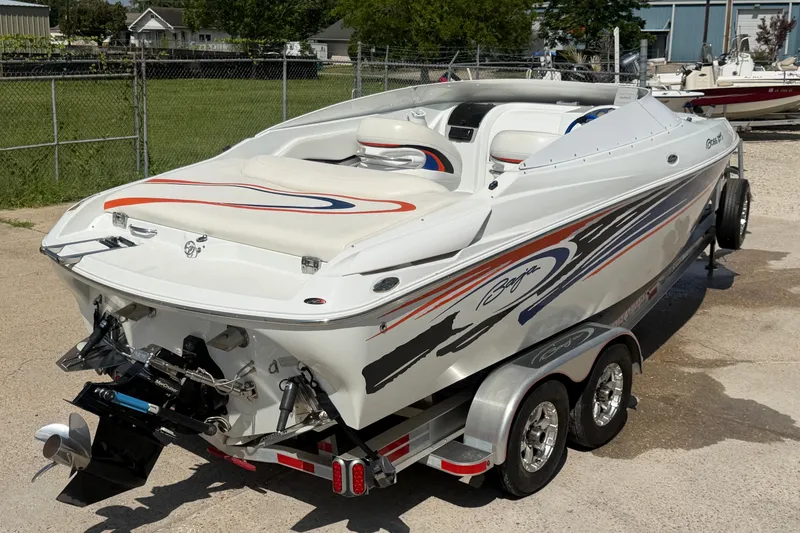 Slide: The Image of 2004 Baja 245 Performance boat on trailer, featuring sleek design and vibrant graphics. - 8