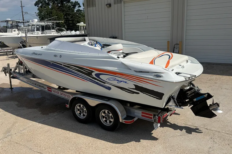 Slide: The Image of 2004 Baja 245 Performance boat on trailer, featuring sleek design and vibrant graphics. - 5