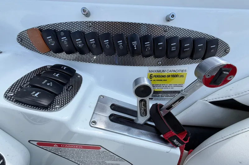 Slide: The Image of Control panel of a 2004 Baja 245 Performance boat with switches and throttle. - 20