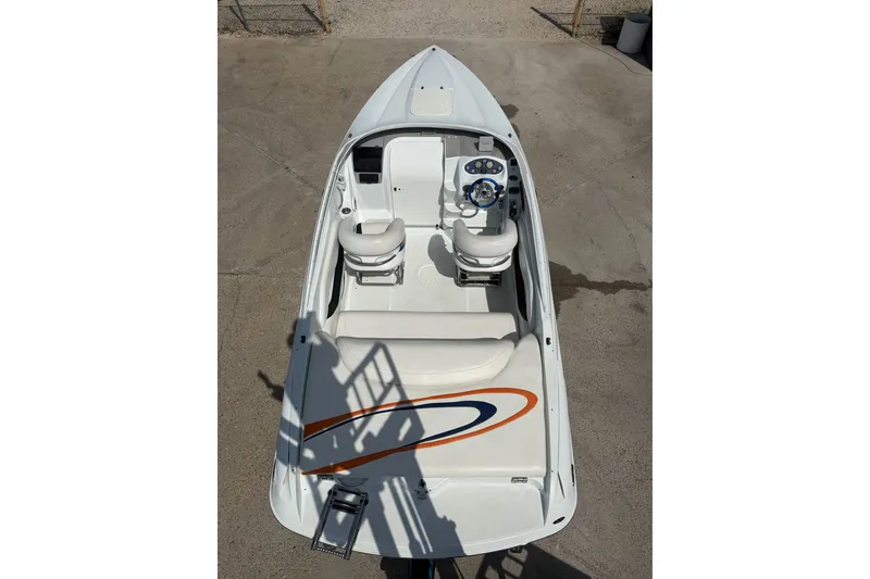 Slide: The Image of 2004 Baja 245 Performance boat, top view, white interior, dual seats, sleek design. - 10