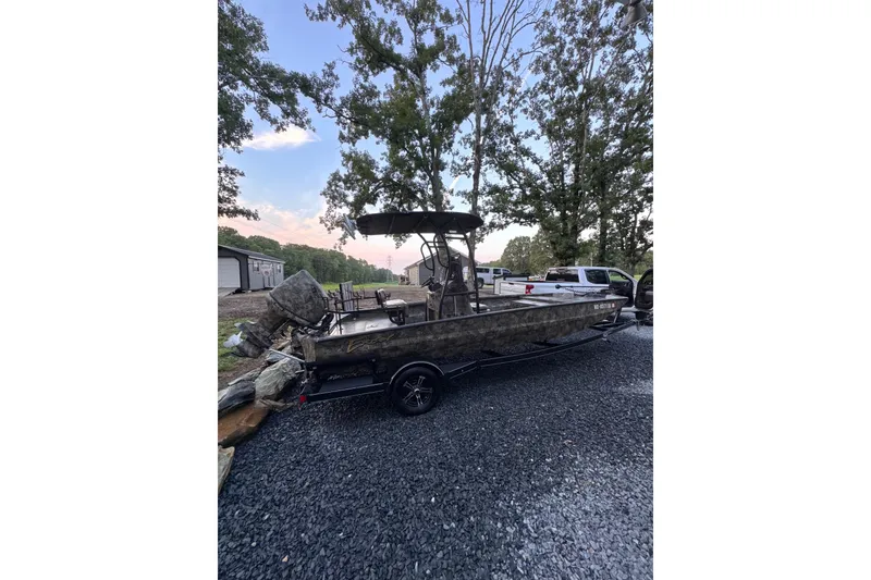 The Image of 2023 Excel 2172 Stalker CC boat on trailer, parked outdoors near trees. - 1
