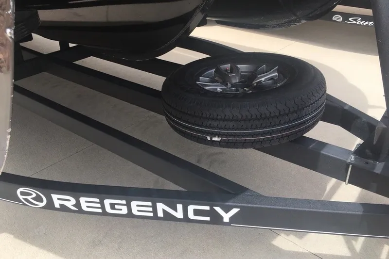 Slide: The Image of 2023 Regency 250LE trailer with spare tire mounted underneath. - 7