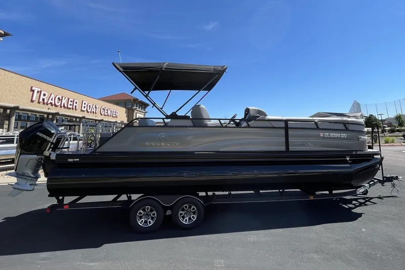 Slide: The Image of 2023 Regency 250LE pontoon boat at Tracker Boat Center, sunny day. - 4