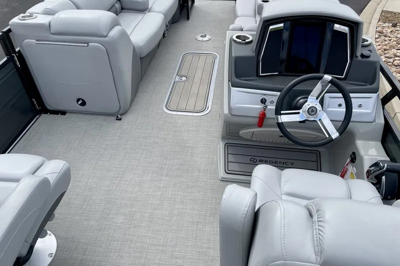 Slide: The Image of 2023 Regency 250LE boat interior with plush seating and modern steering console. - 4