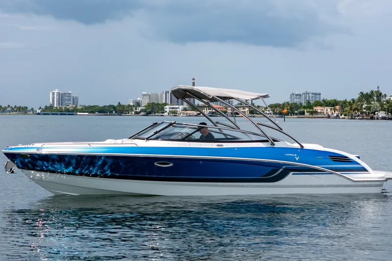 The Image of 2019 Formula 270 Bowrider boat on calm water with cityscape background. - 1