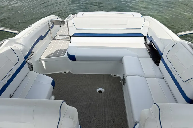 Slide: The Image of 2019 Formula 270 Bowrider interior with white and blue seating, on calm water. - 21