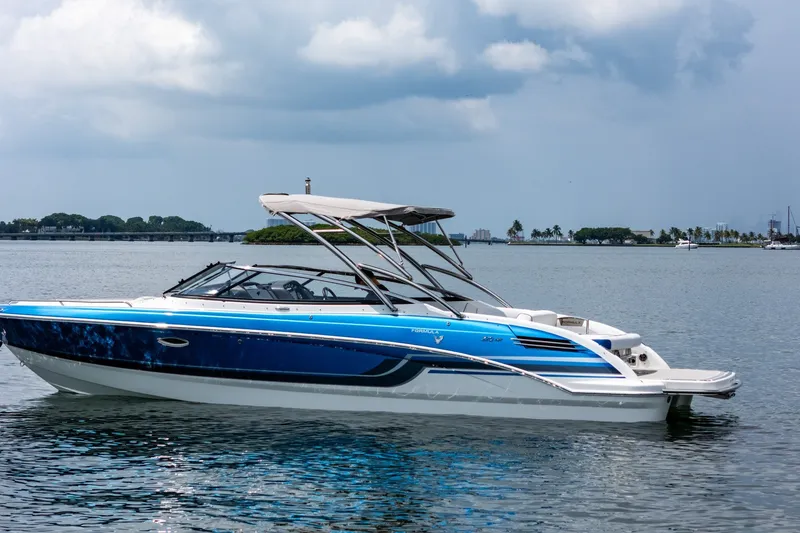 Slide: The Image of 2019 Formula 270 Bowrider boat on calm water under cloudy sky. - 4