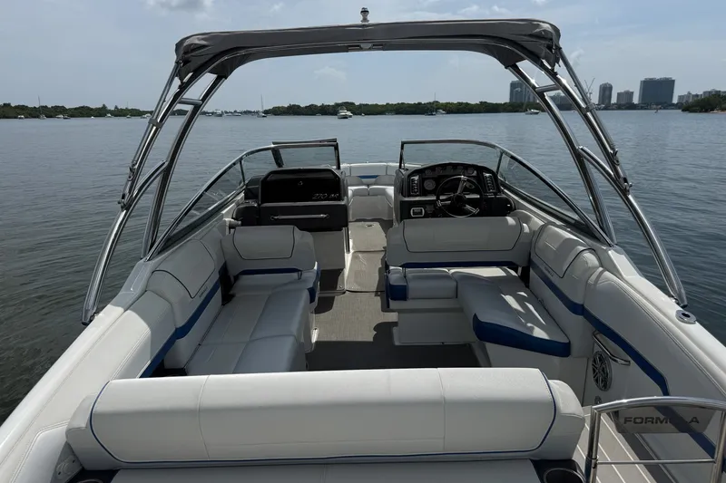 Slide: The Image of 2019 Formula 270 Bowrider boat interior with spacious seating and sleek design on calm water. - 10