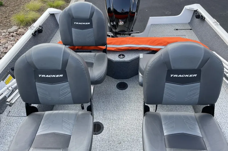 Slide: The Image of 2020 Tracker Pro Guide V-16 WT boat interior with gray seats and orange life jacket. - 5