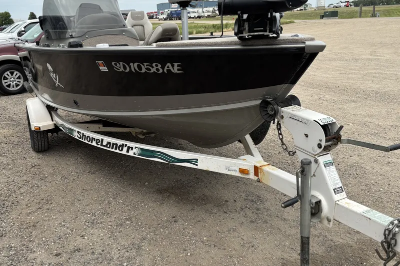 Slide: The Image of 2001 Lund Mr. Pike 16 boat on ShoreLand'r trailer in parking lot. - 1