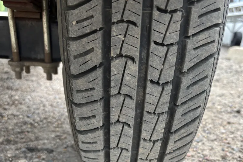 Slide: The Image of Close-up of a tire tread on a 2001 Lund Mr. Pike 16 trailer. - 7