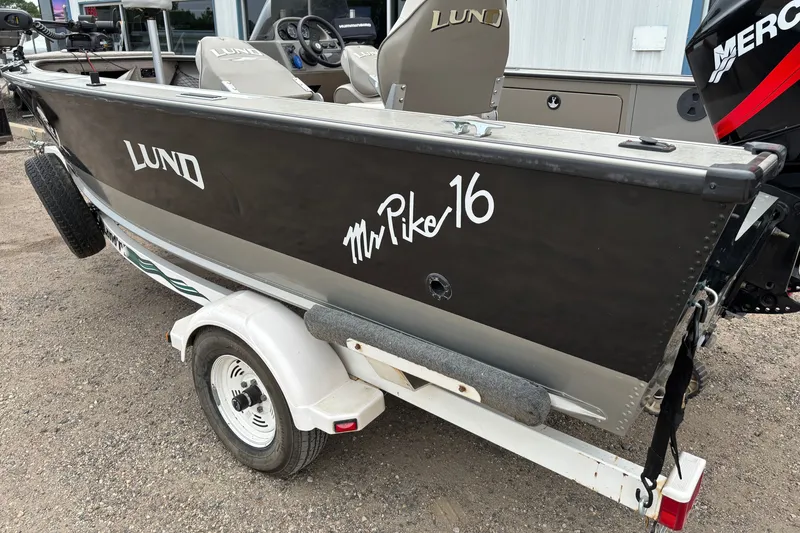 Slide: The Image of 2001 Lund Mr. Pike 16 fishing boat on trailer, featuring a Mercury outboard motor. - 5