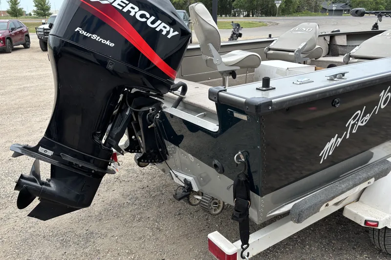 Slide: The Image of 2001 Lund Mr. Pike 16 boat with Mercury FourStroke engine on a trailer. - 3
